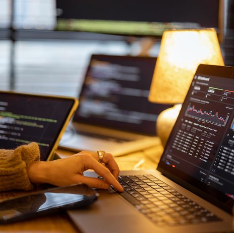 Woman working on some programming dashboard on laptop, close-up on hands and keyboard. Programmer, software tester or analyst working online